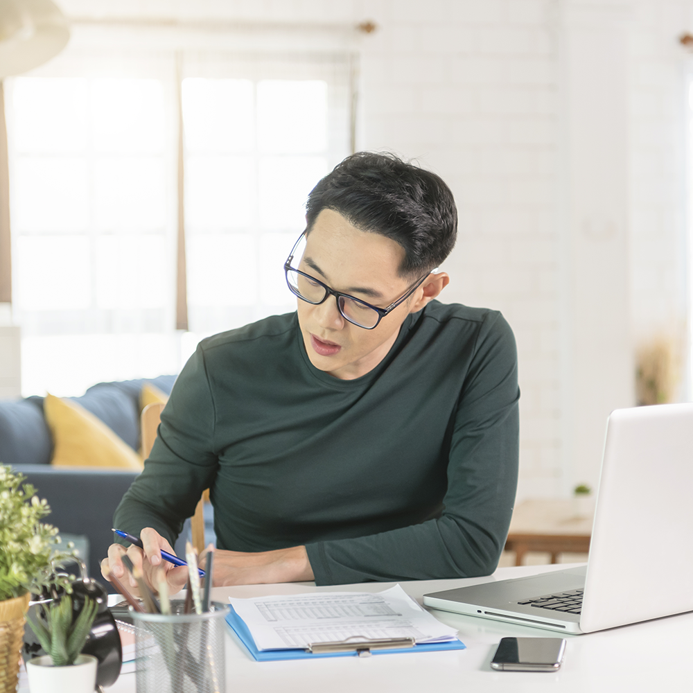 handsome asian businessman working from home